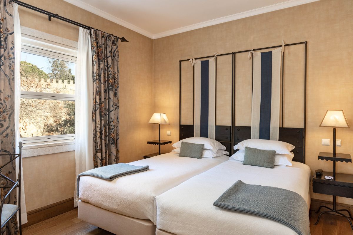 a room with two beds and a window