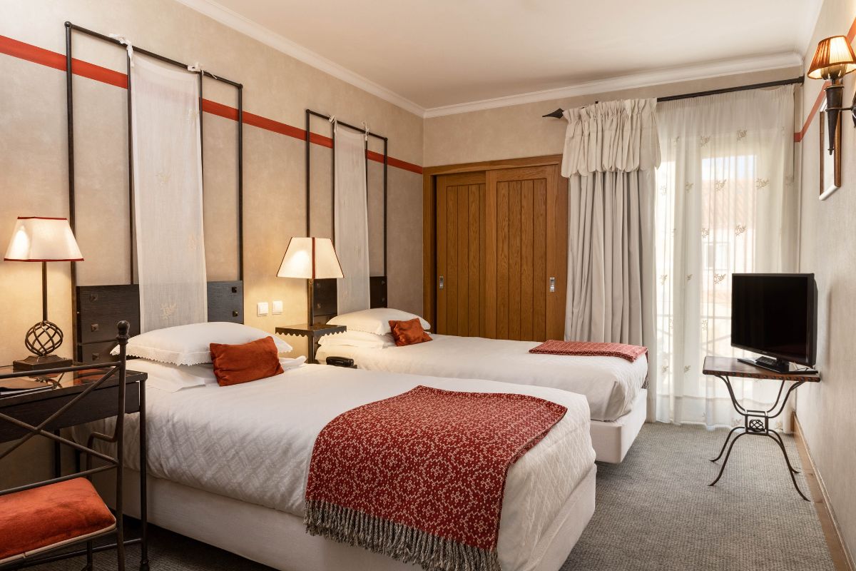 a room with two beds and a door