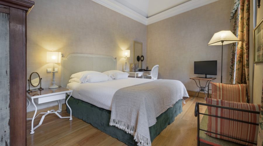 a bedroom with a bed and a tv