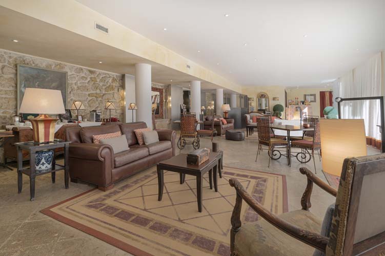 a room with a couch and chairs