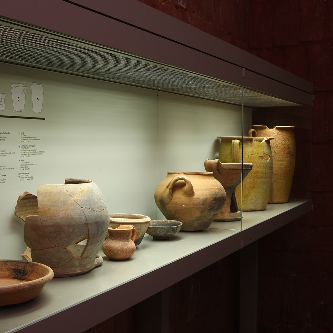 a shelf with pottery on it