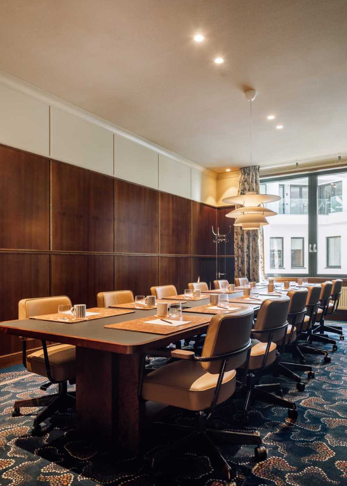 a room with a long table and chairs