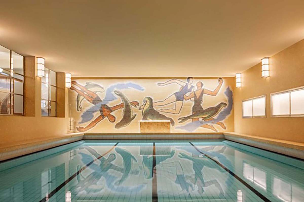 a swimming pool with a mural on the wall