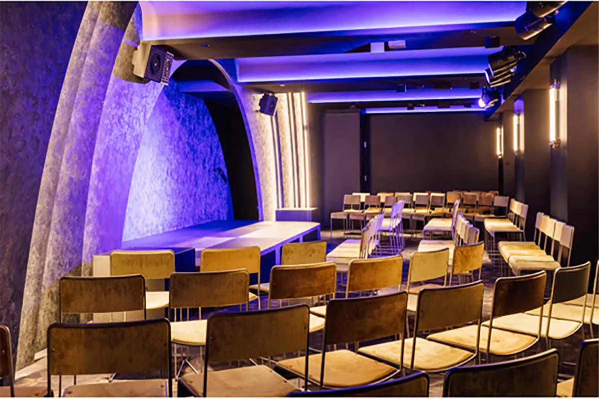 a room with rows of chairs and a stage