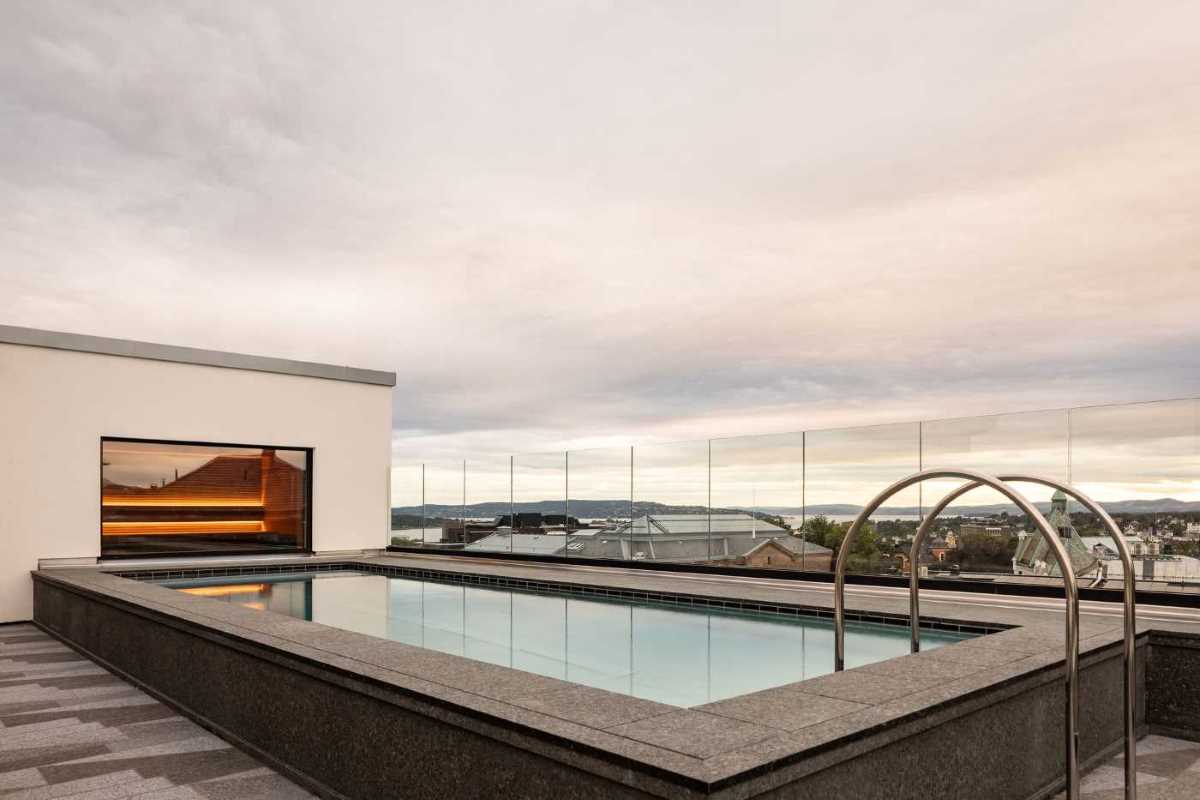 a pool with a railing on the side of a building