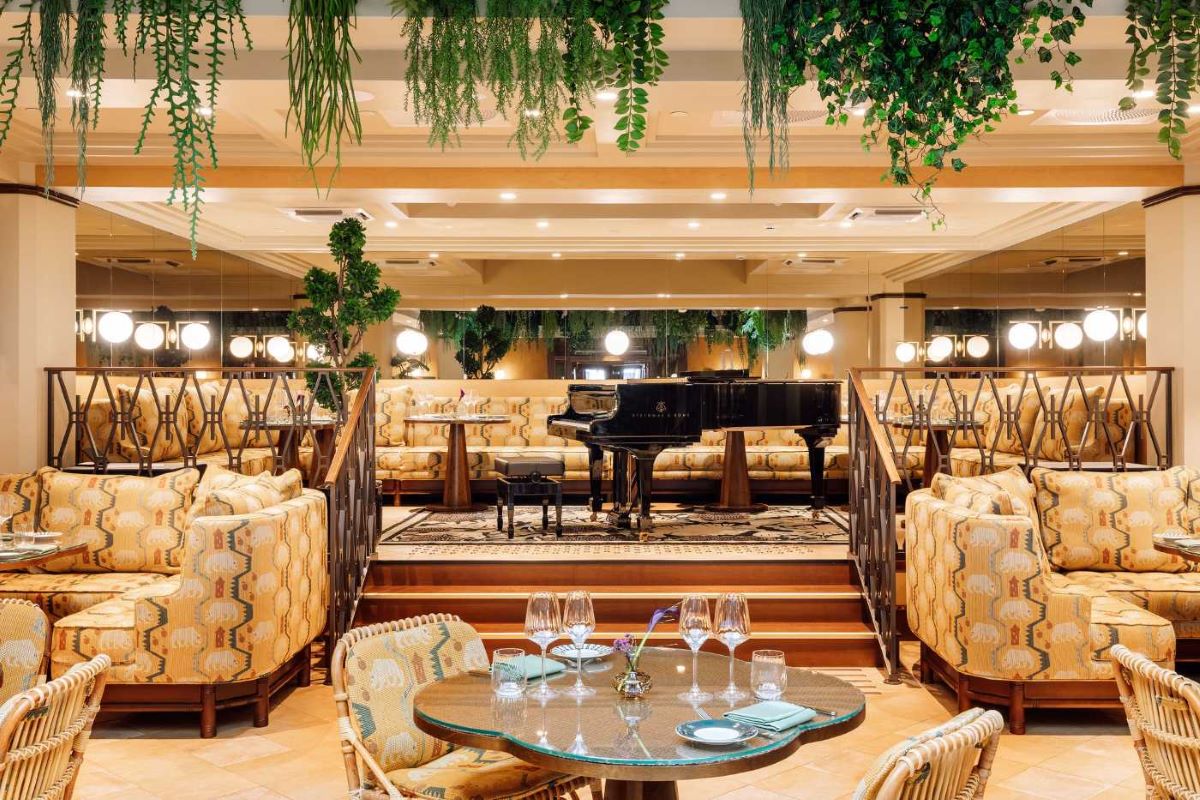 a room with a piano and chairs
