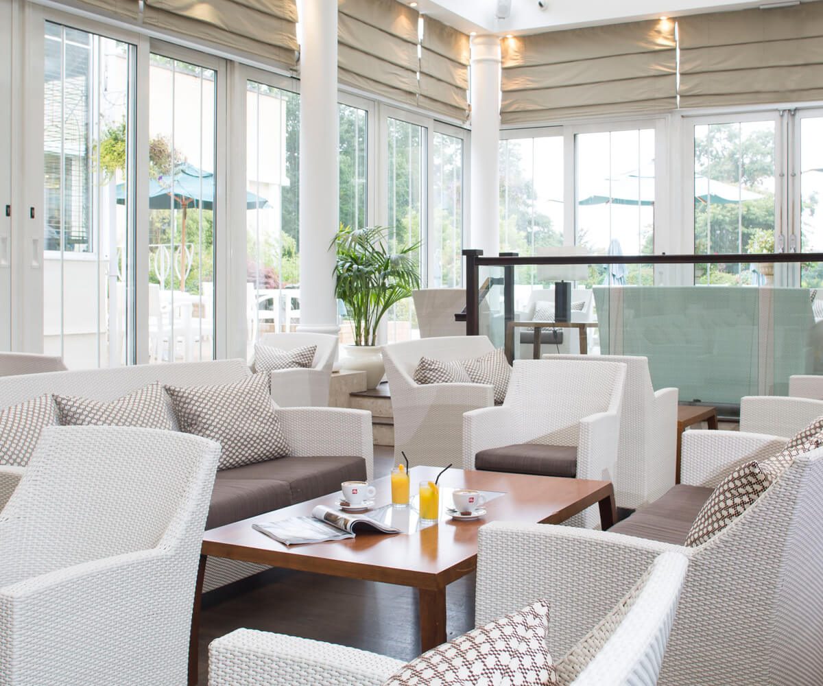 a room with white furniture and a table
