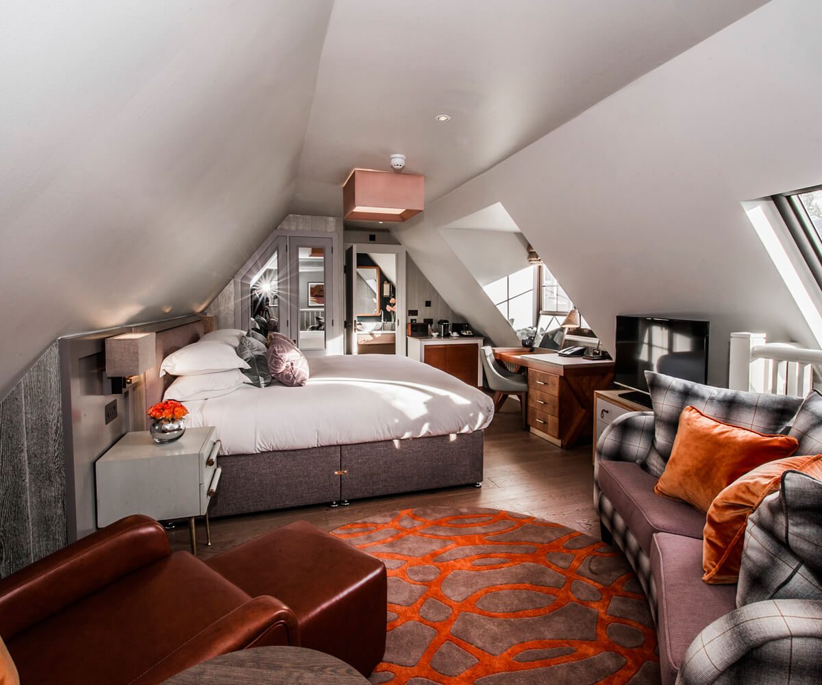 a bedroom with a bed and a couch