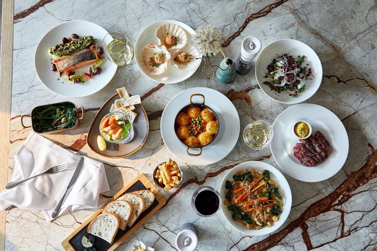 a table with plates of food and drinks