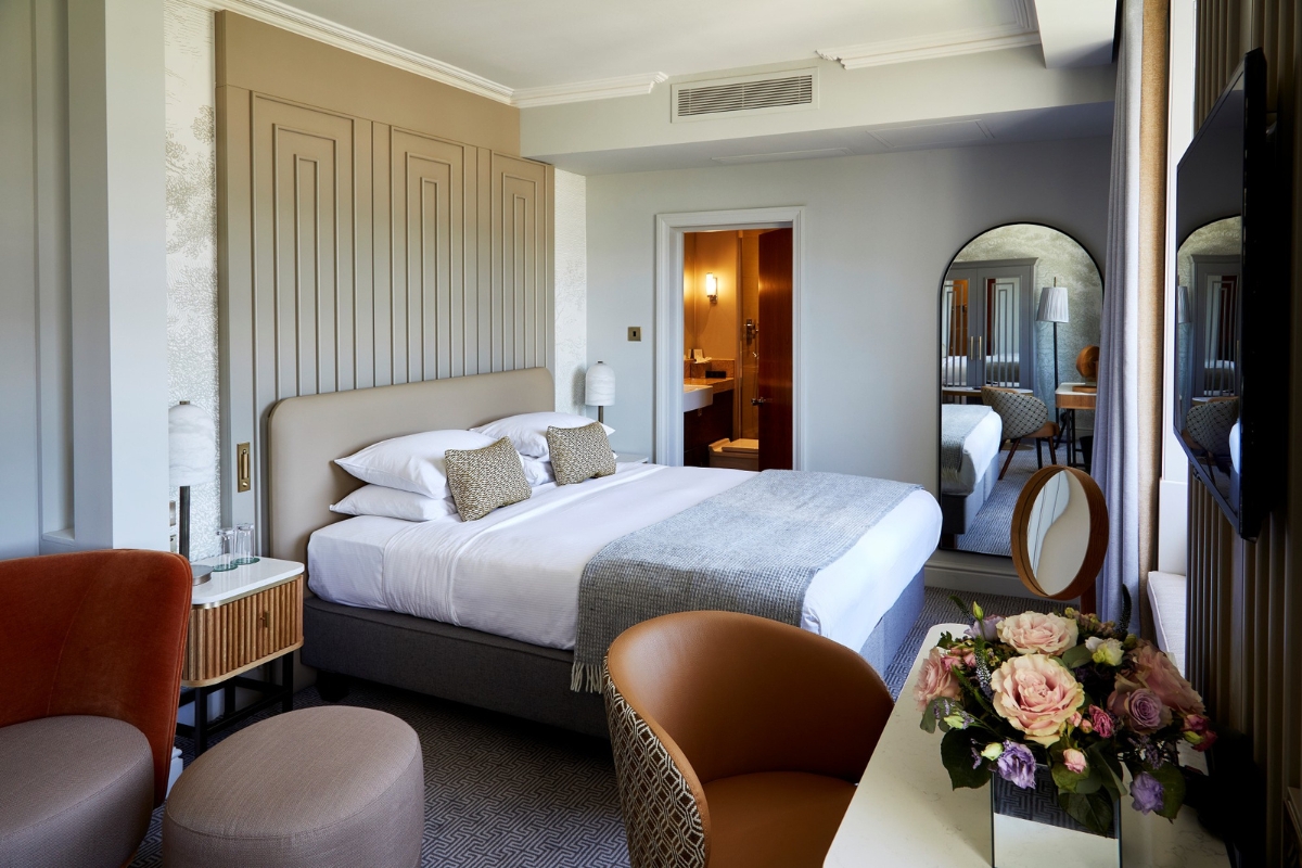 a bedroom with a bed and a mirror