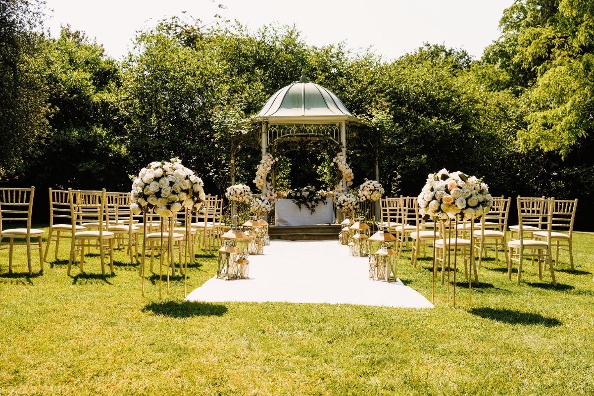 a wedding ceremony with chairs and flowers