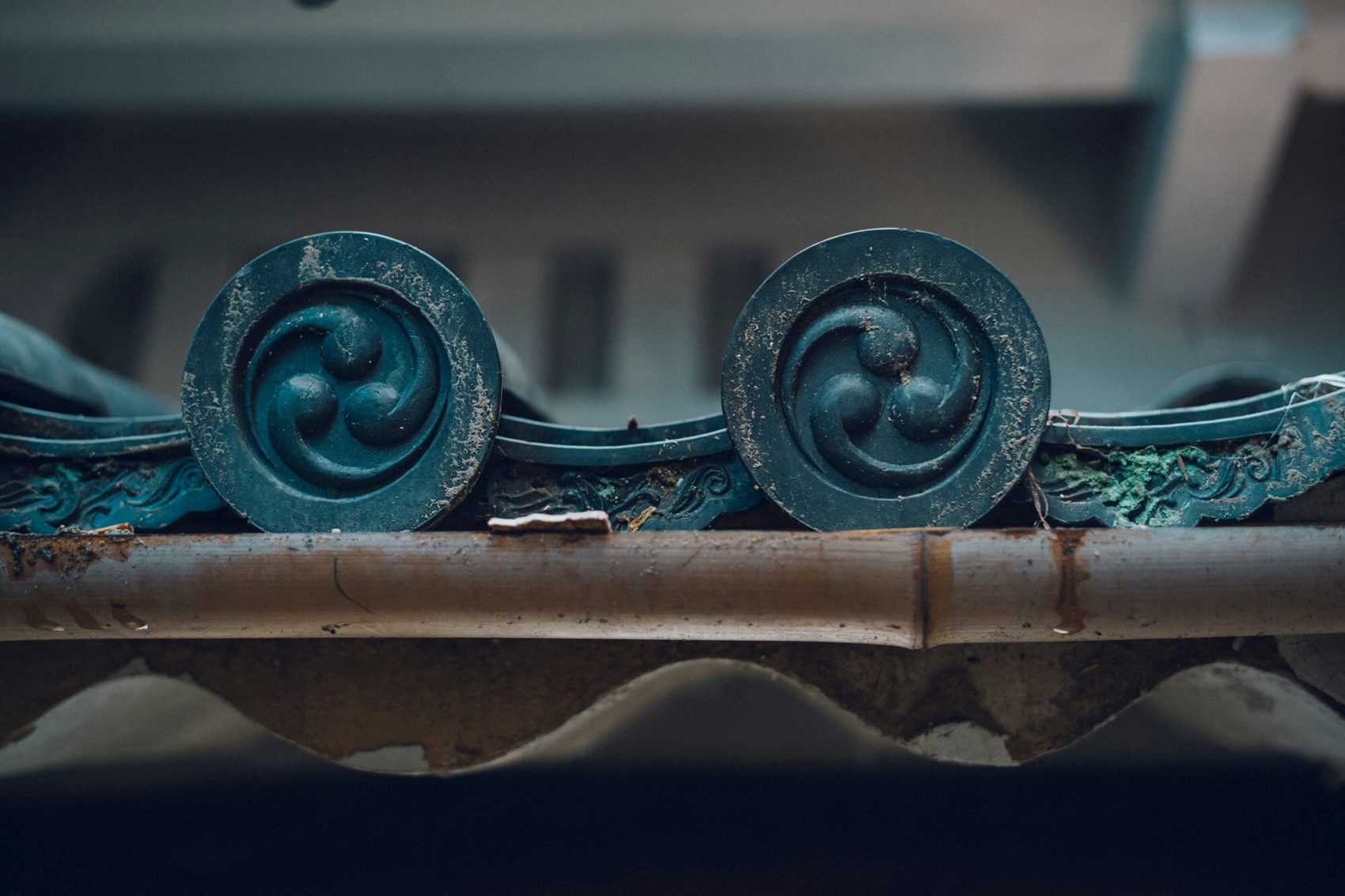 a blue metal object with swirls on it
