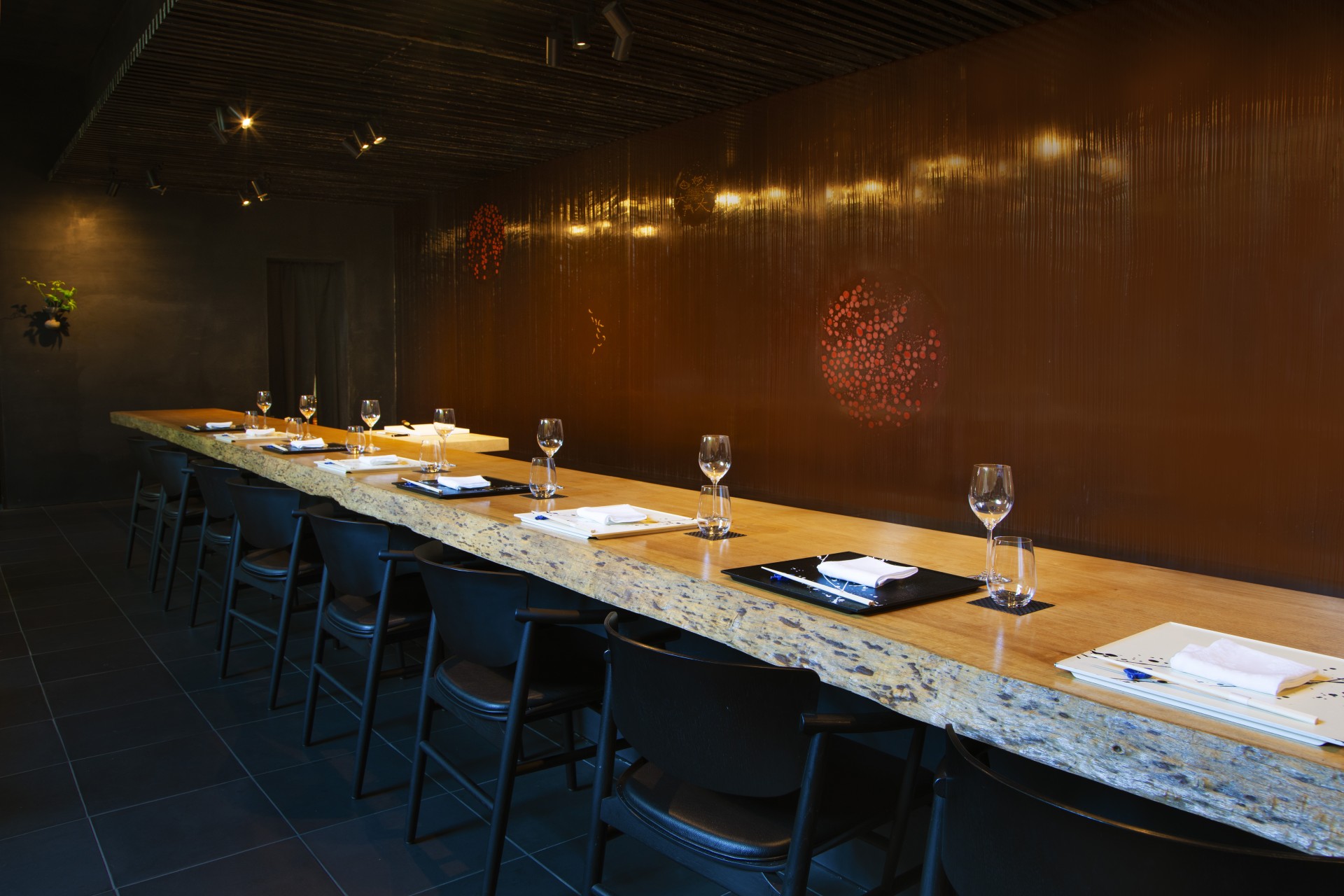 a long table with wine glasses and plates on it