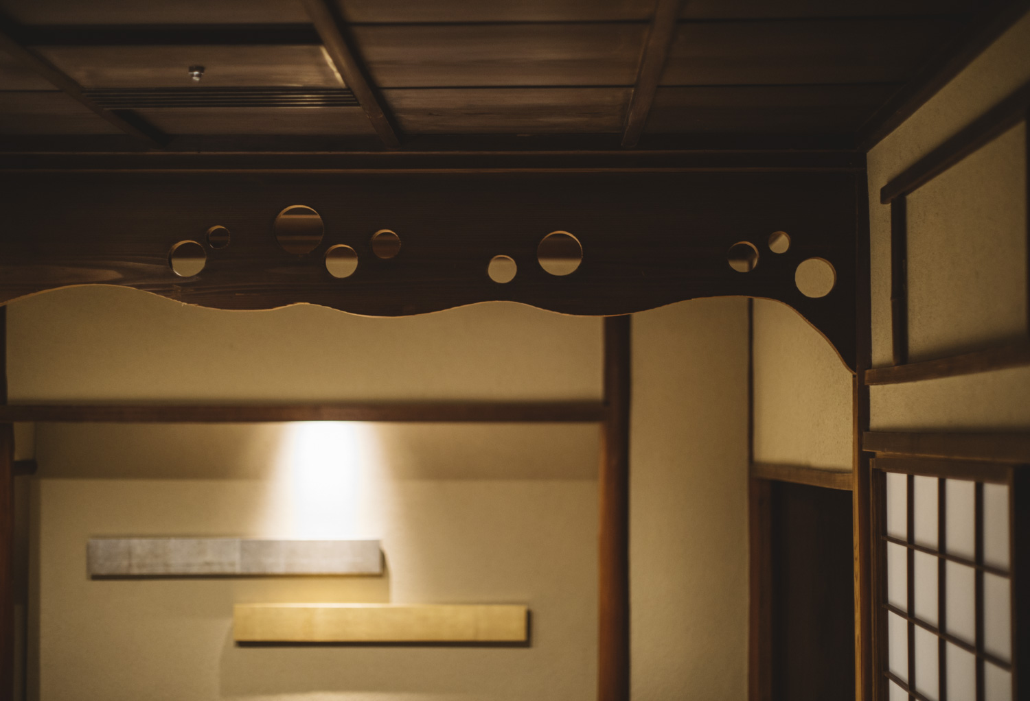 a wood structure with holes and a light on the ceiling