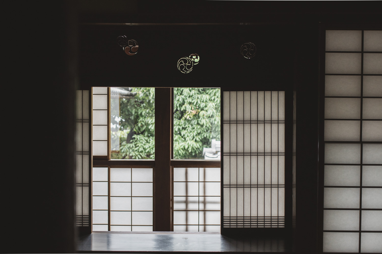 a room with a window and paper doors