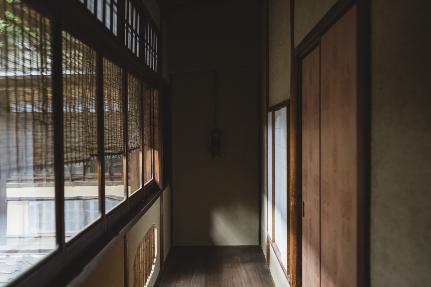 a hallway with a wooden floor and a window