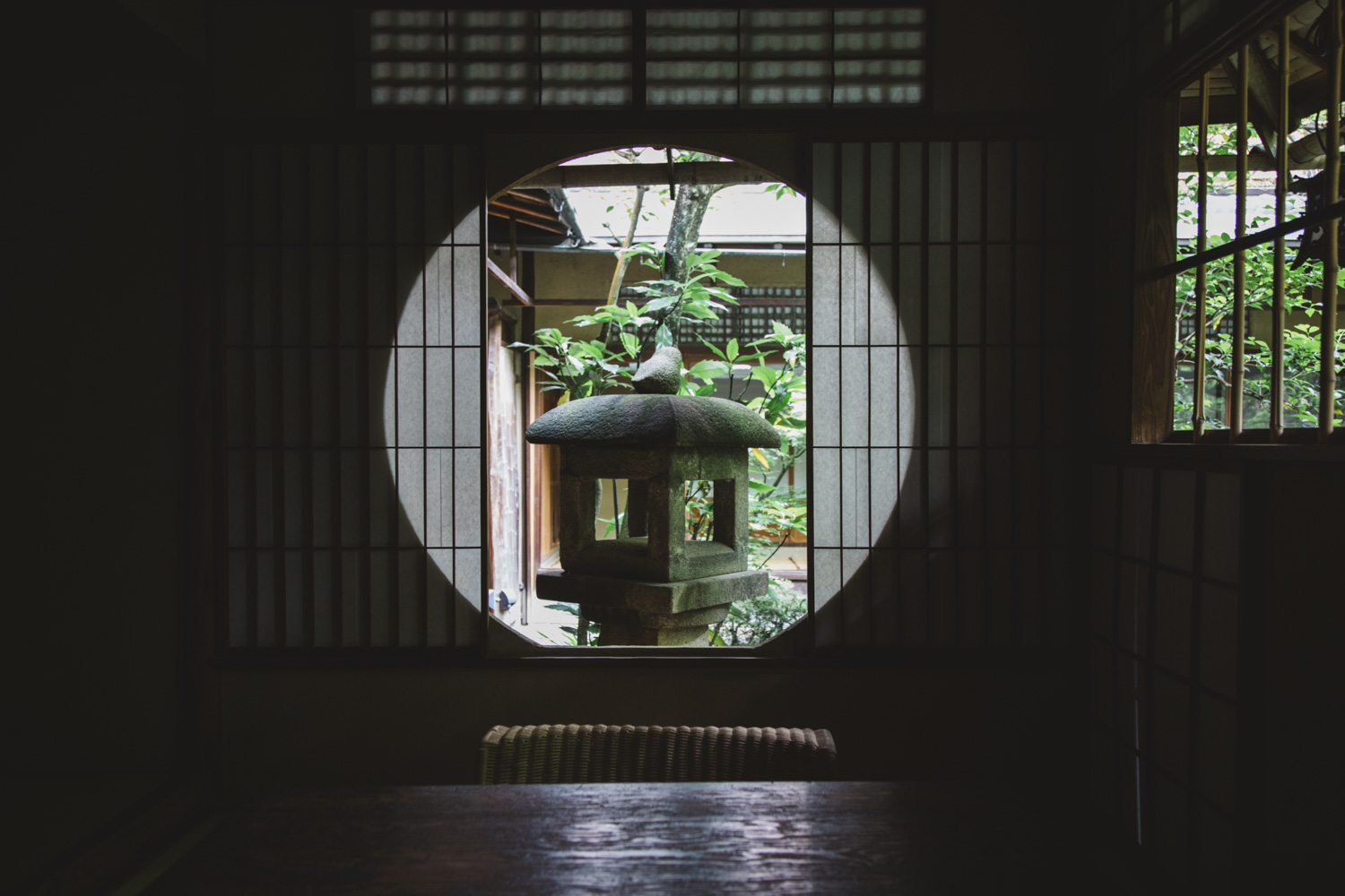 a round window with a stone lantern in it