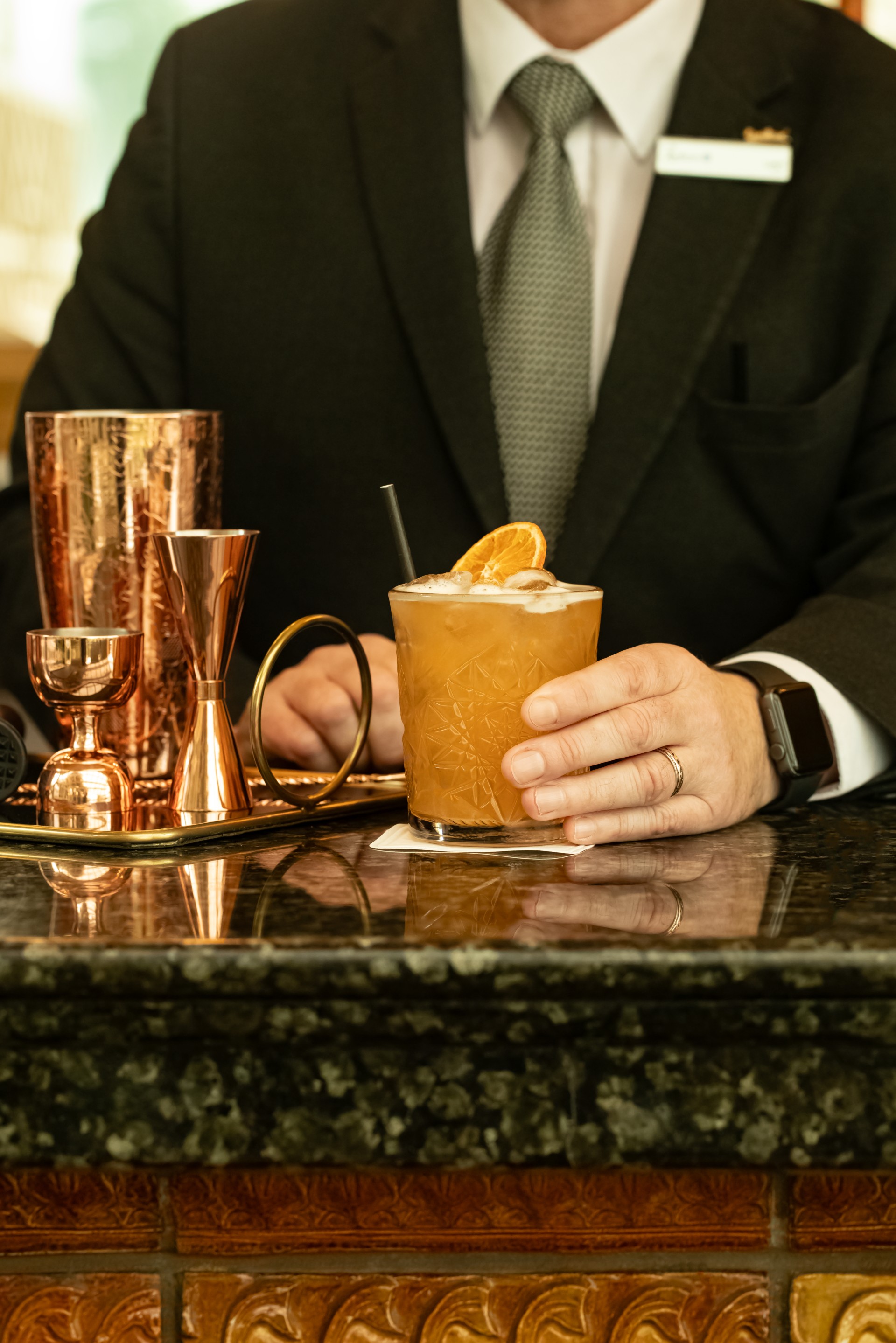 a person holding a glass of liquid