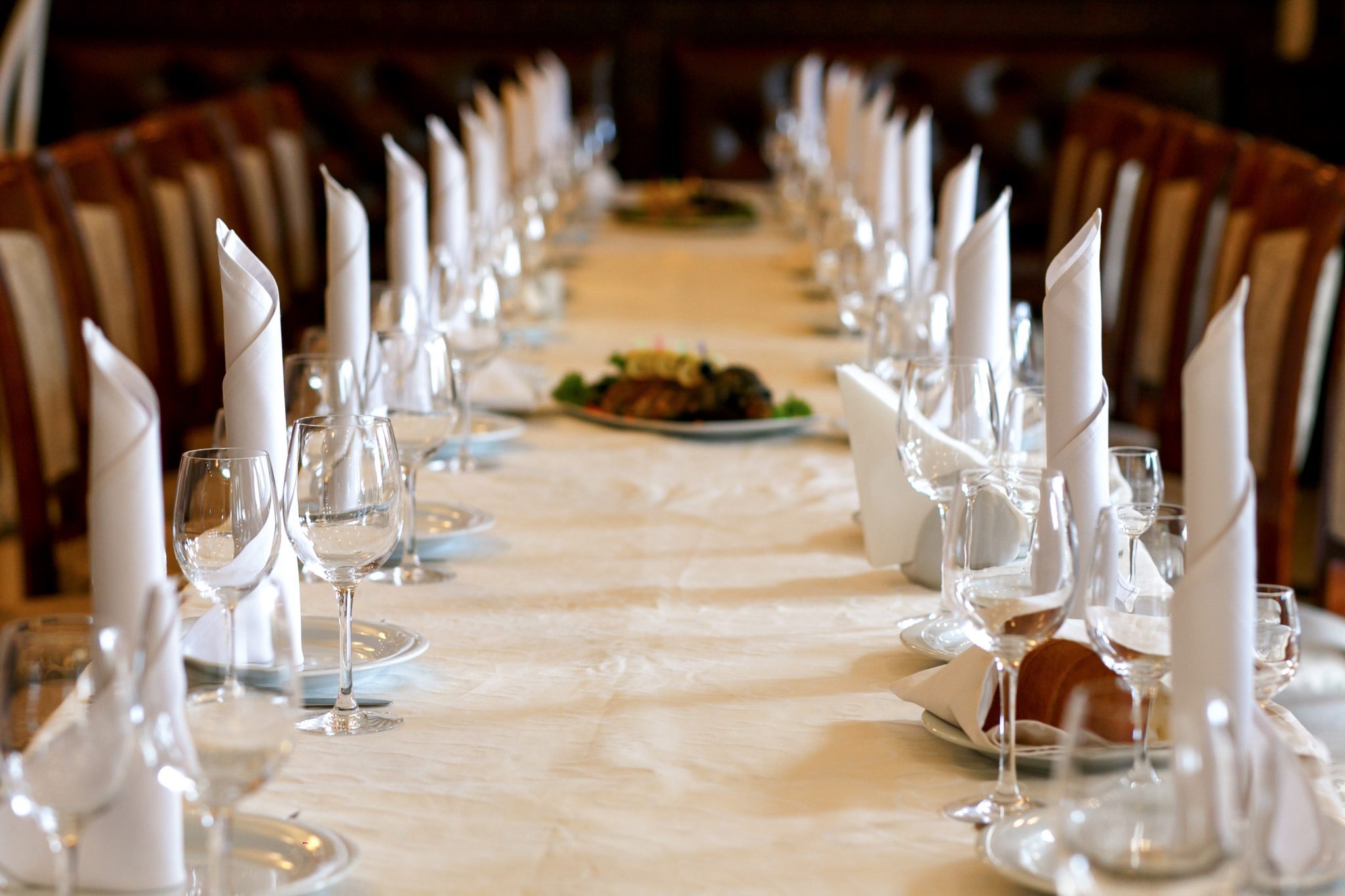 a long table with plates and glasses