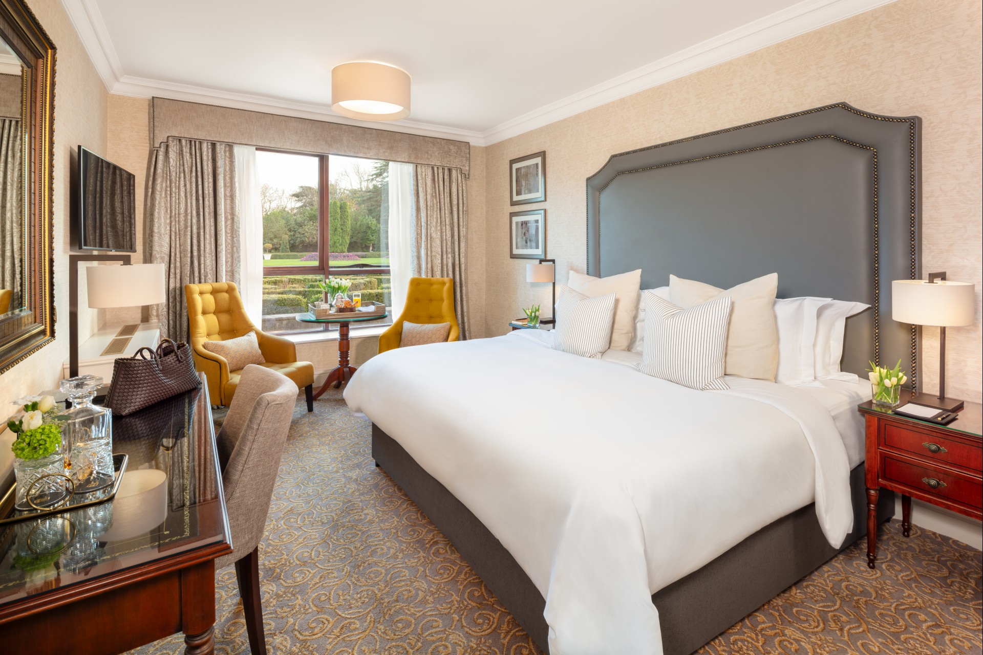 a room with a bed and chairs