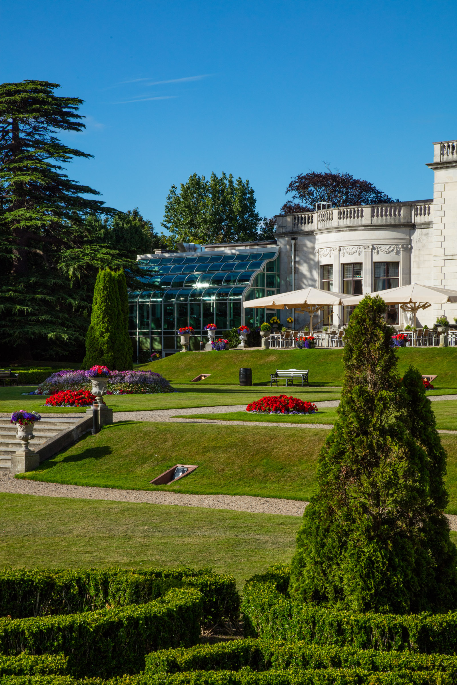 a building with a lawn and flowers