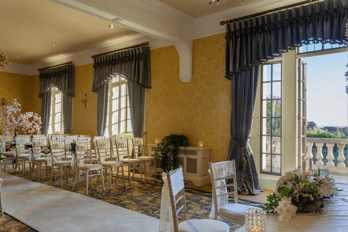 a room with chairs and flowers