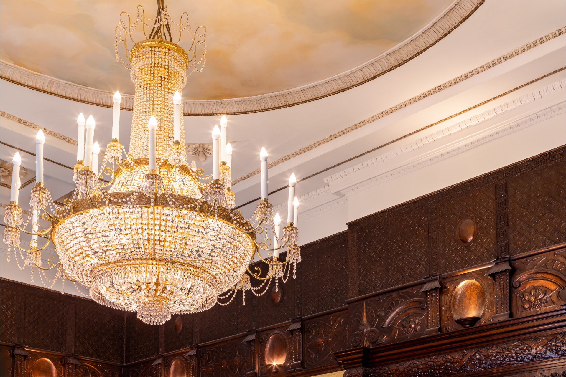 a chandelier with candles from the ceiling