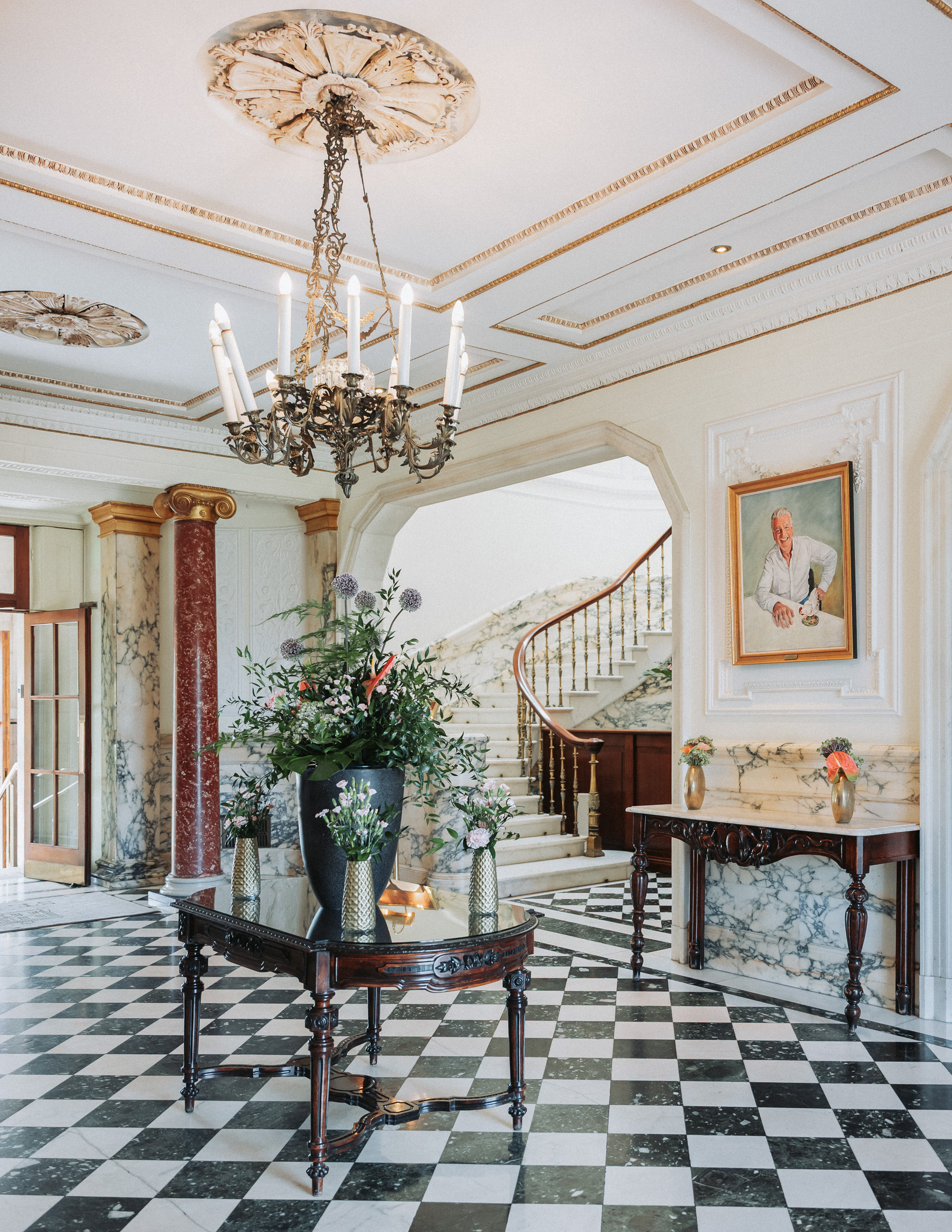 a room with a marble floor and a chandelier