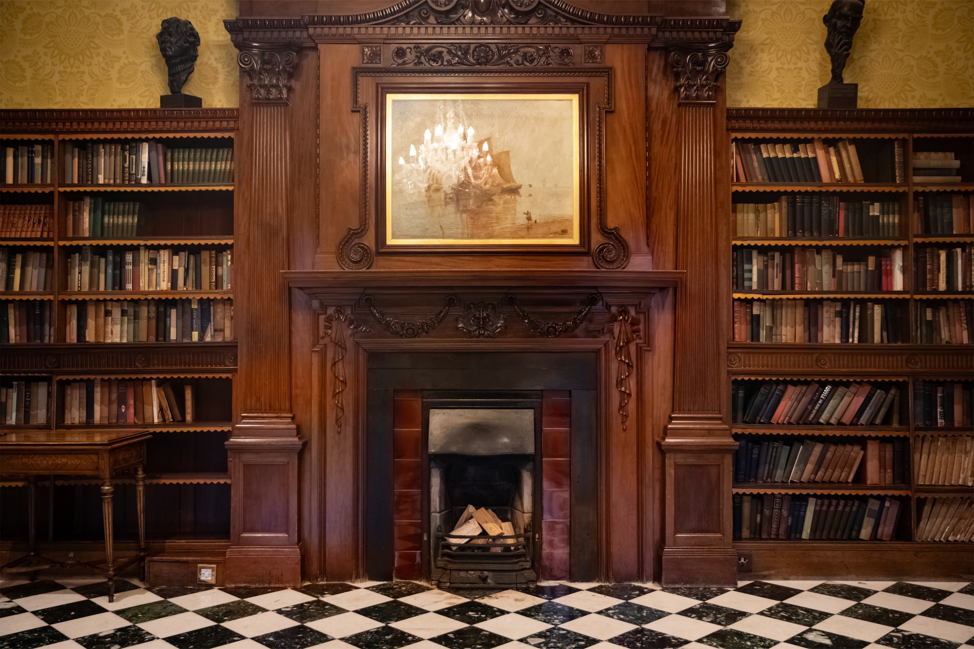 a fireplace in a room with bookshelves