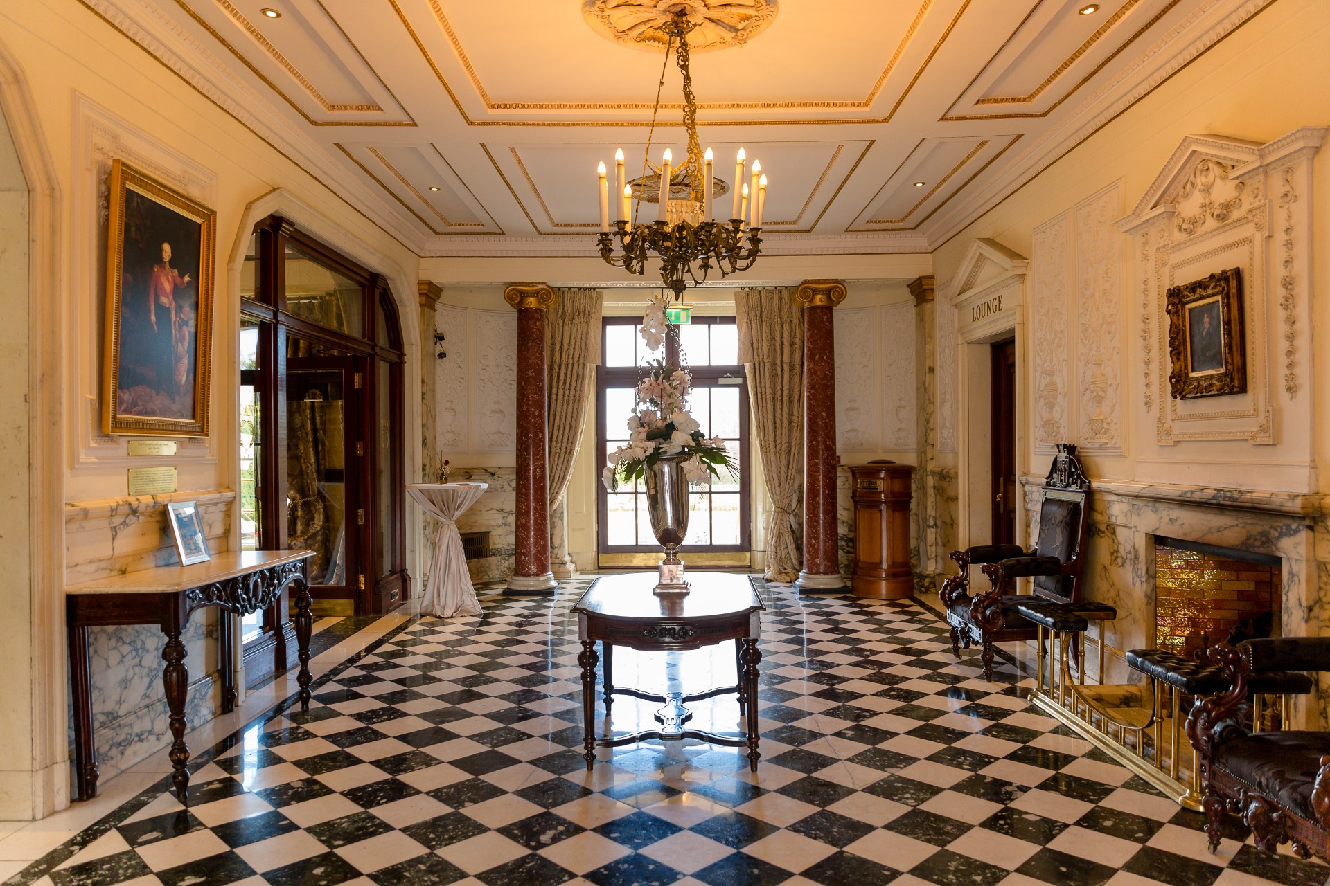a room with a chandelier and a checkered floor