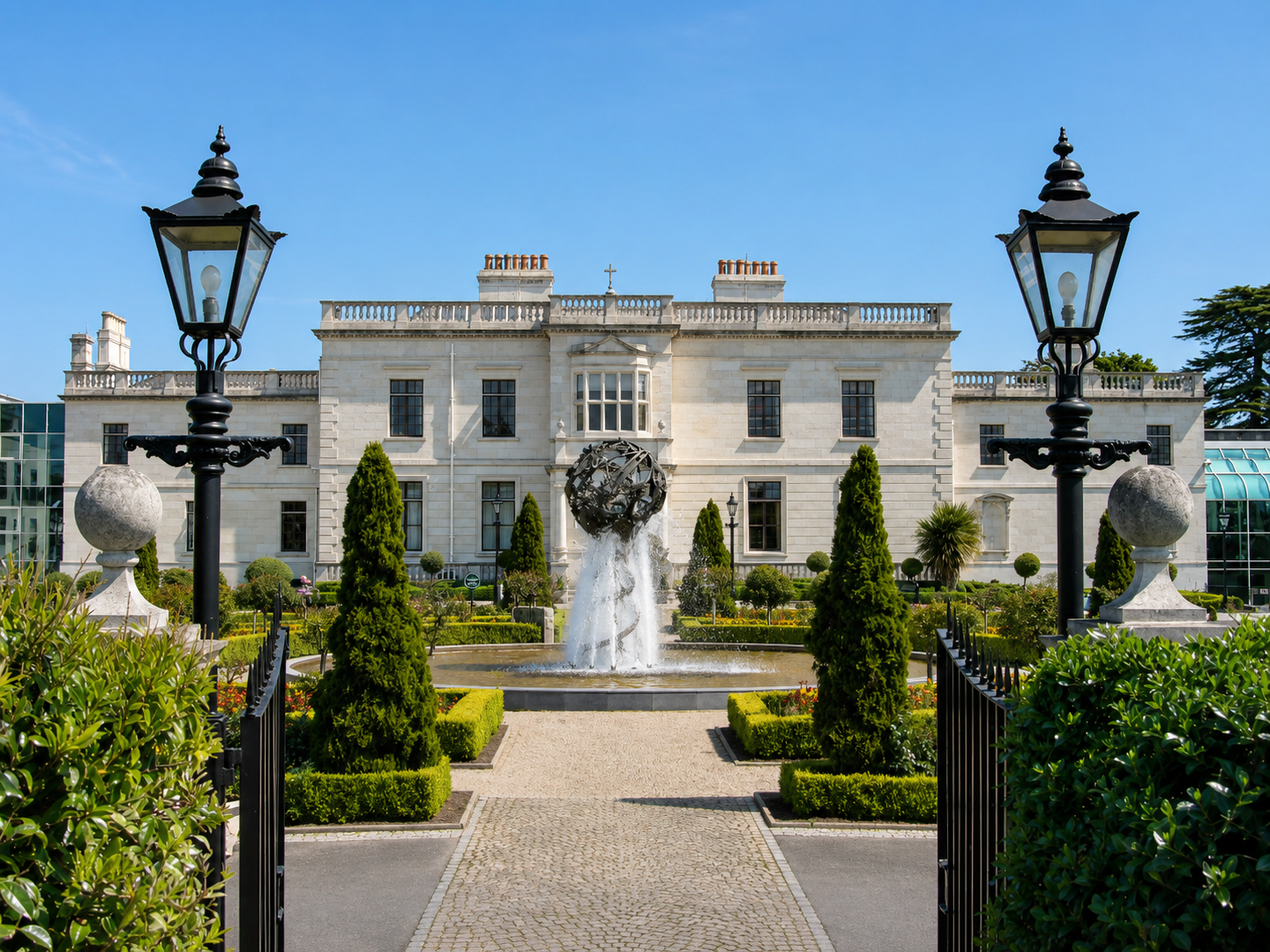 a fountain in front of a large white building