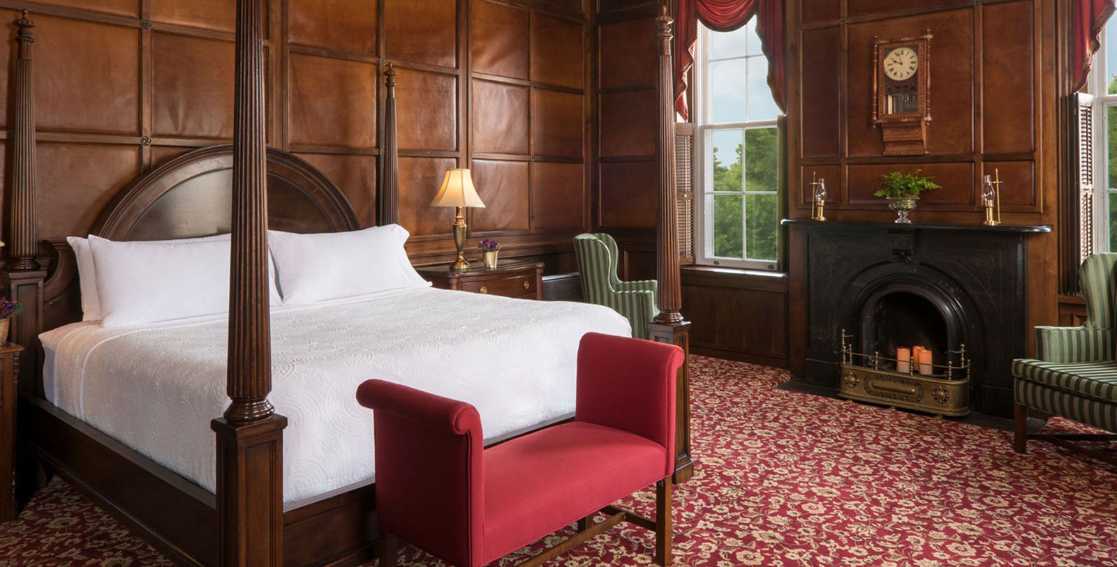 a bedroom with a bed and chairs