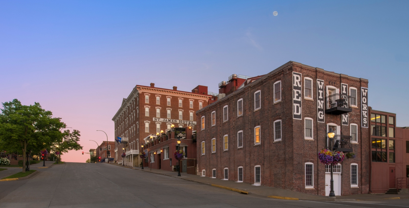 a street with buildings and a moon