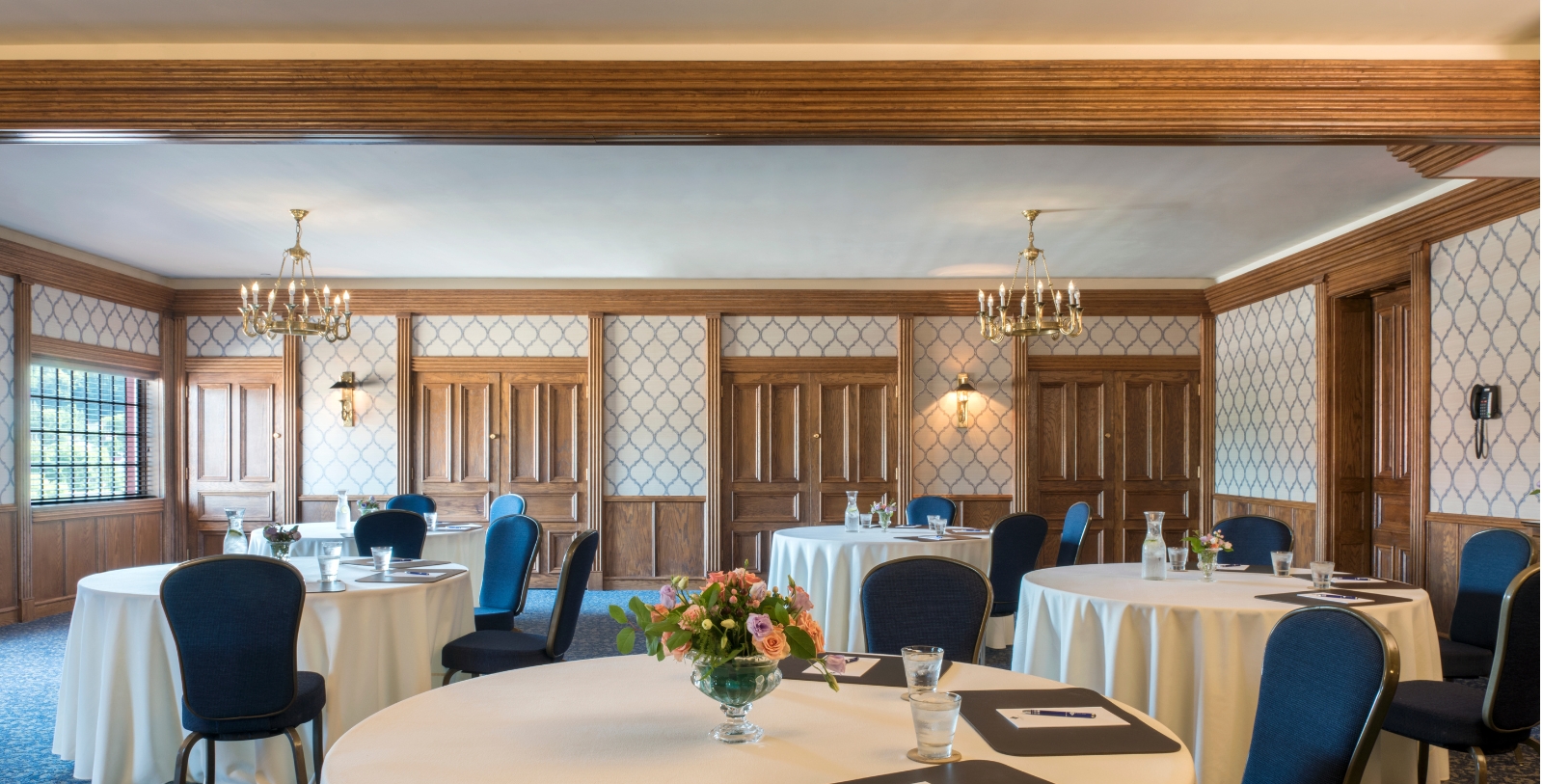 a room with round tables and chairs