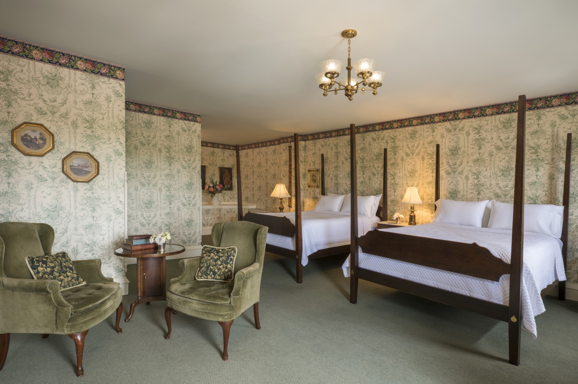 a room with two beds and a chandelier