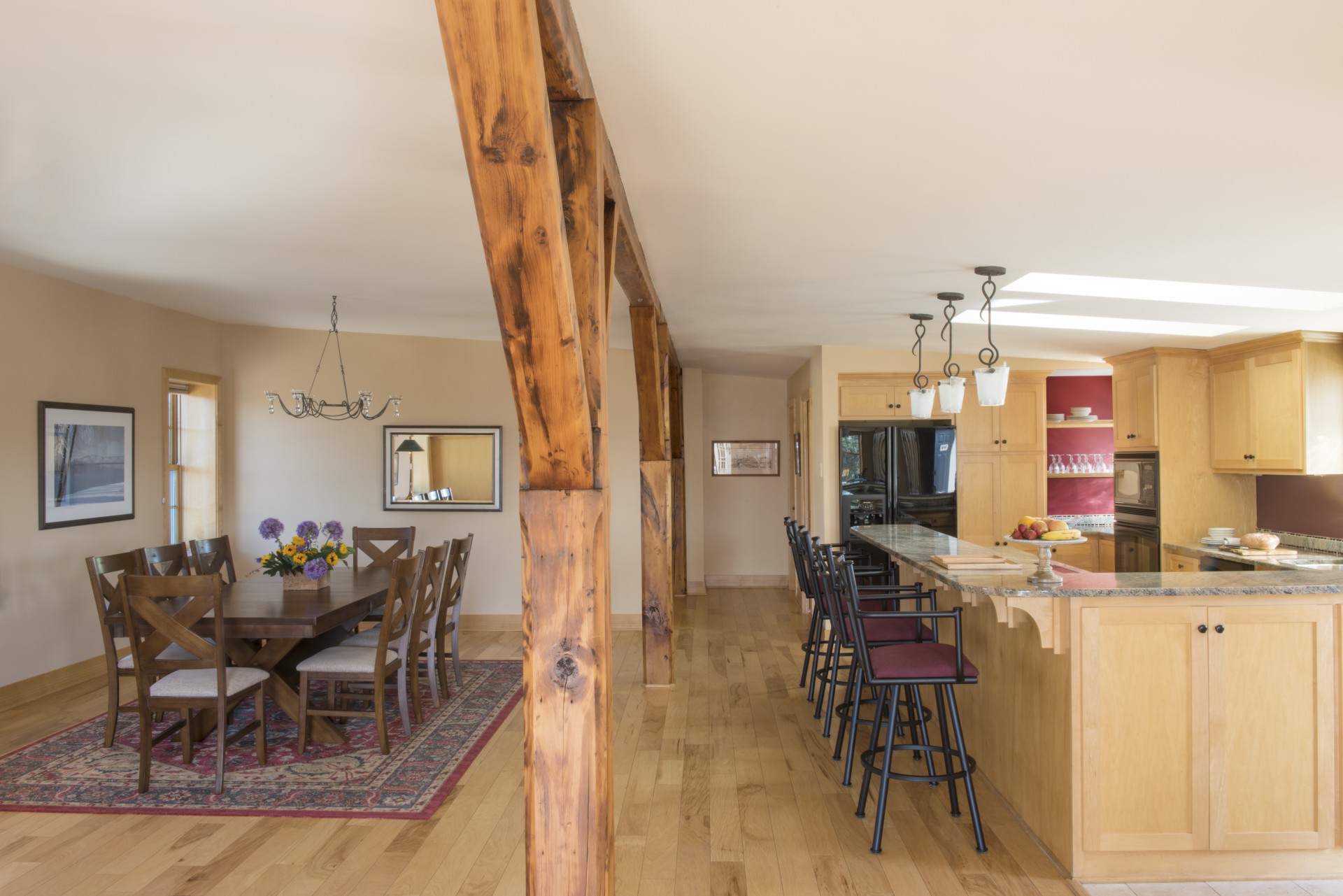 a dining room and kitchen with a table and chairs