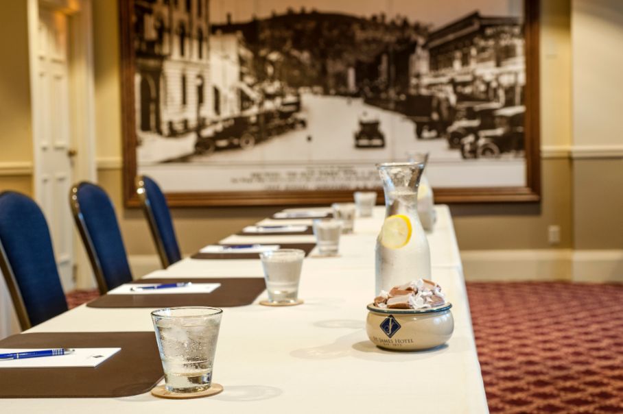 a long table with glasses and a pitcher of water on it