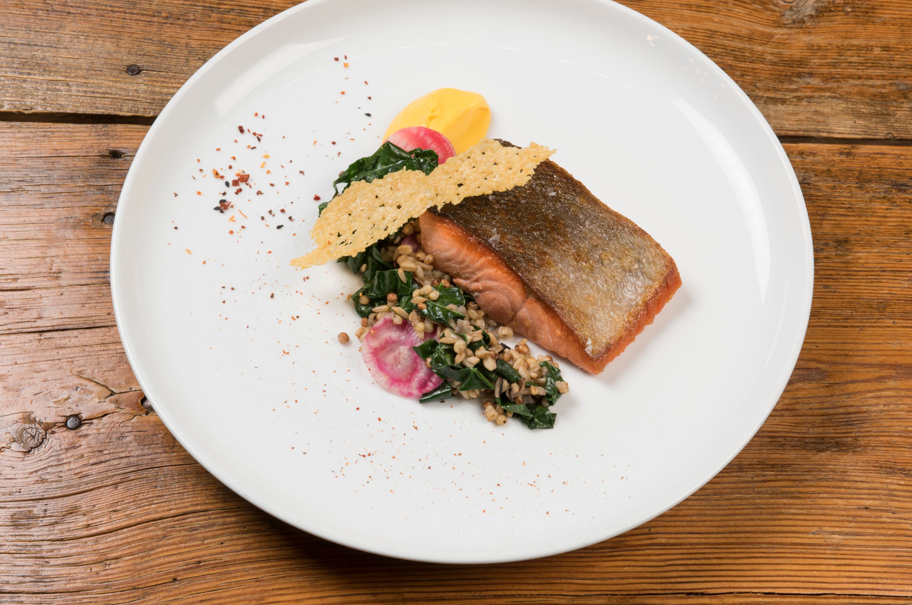 a plate of food on a wood table