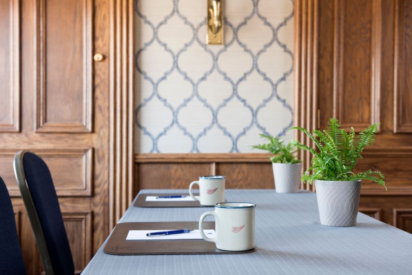 a table with coffee mugs and pen on it