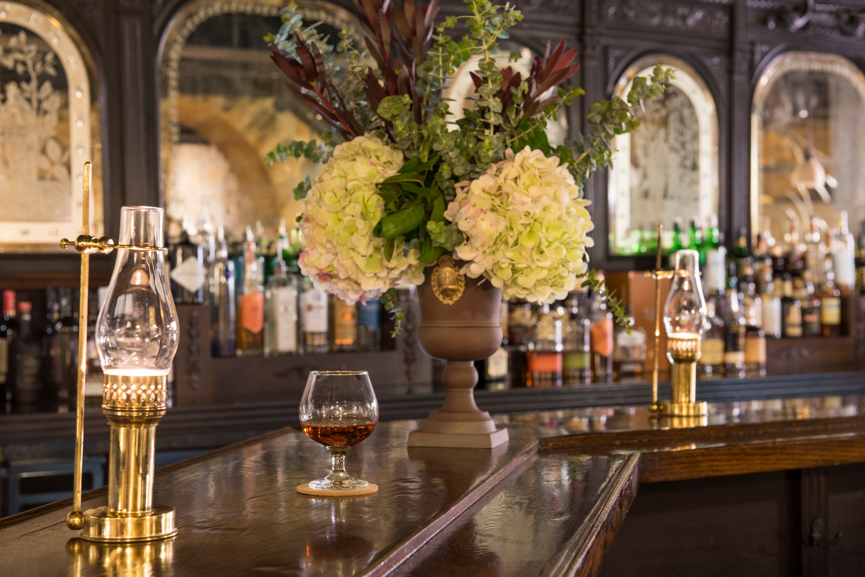a glass of alcohol on a bar