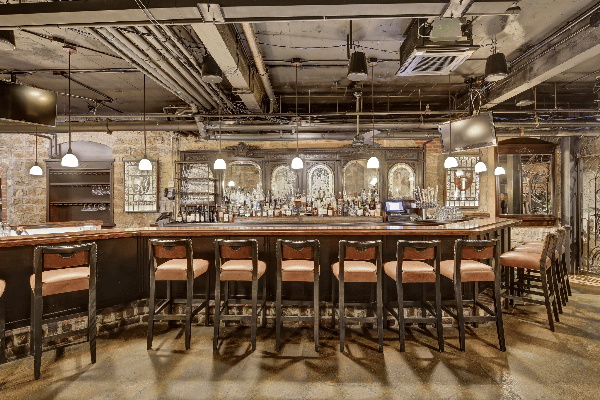 a bar with chairs and a counter