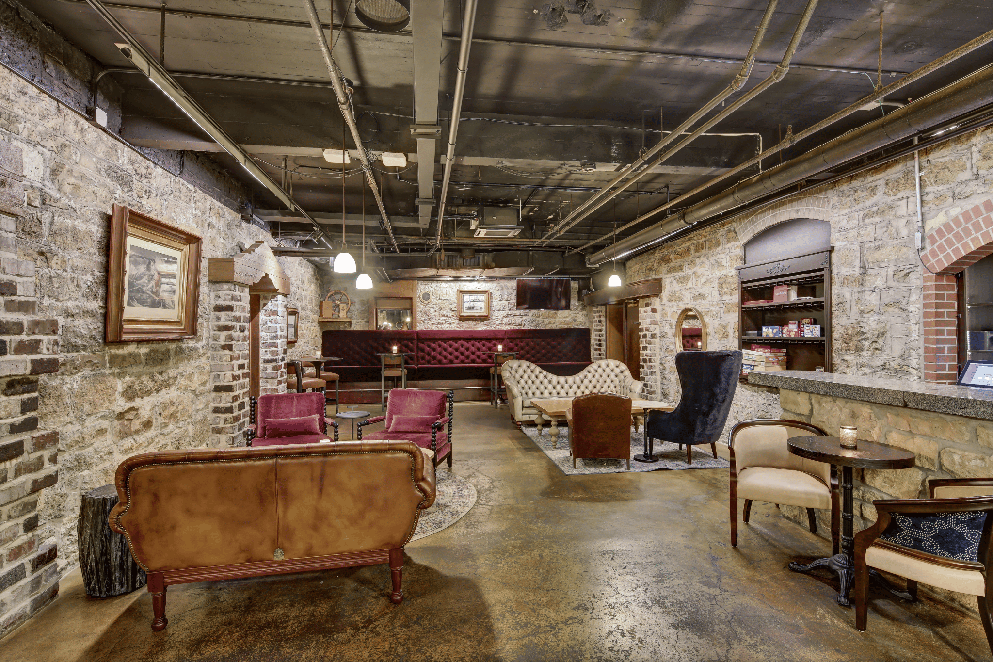 a room with a brick wall and chairs
