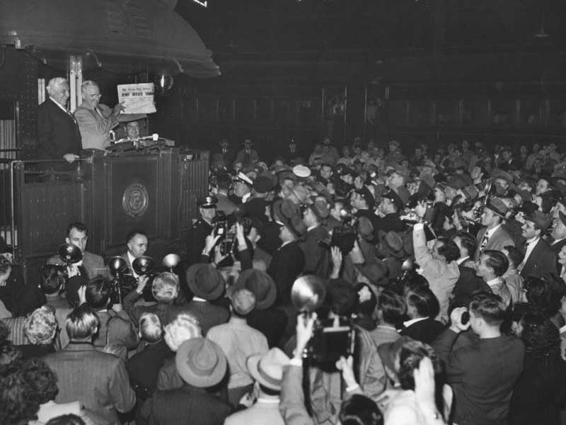 a man standing on podium with a crowd of people