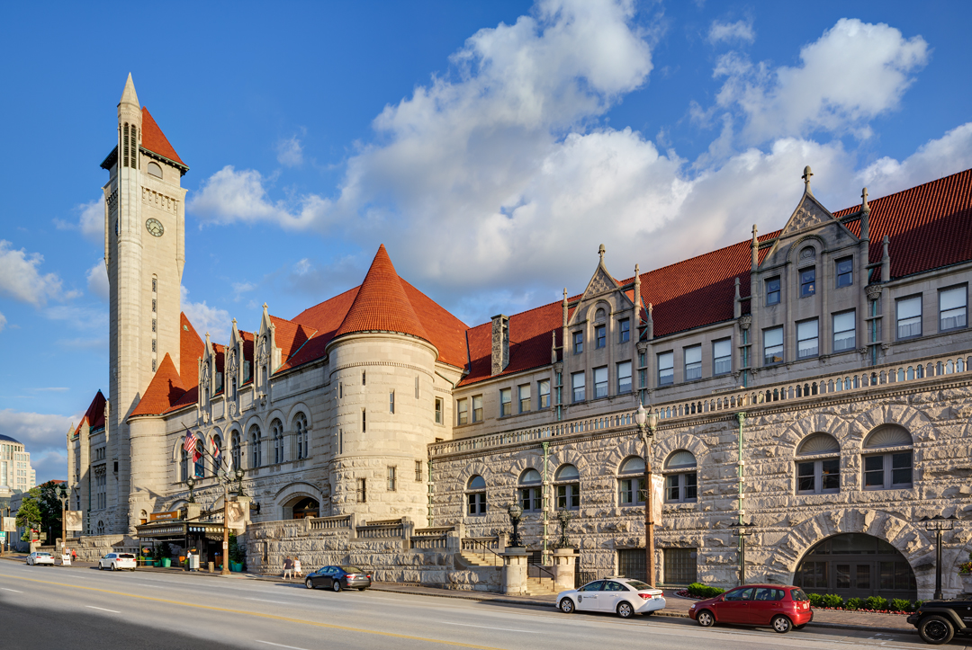 a large stone building with a clock tower with Union Station in the background