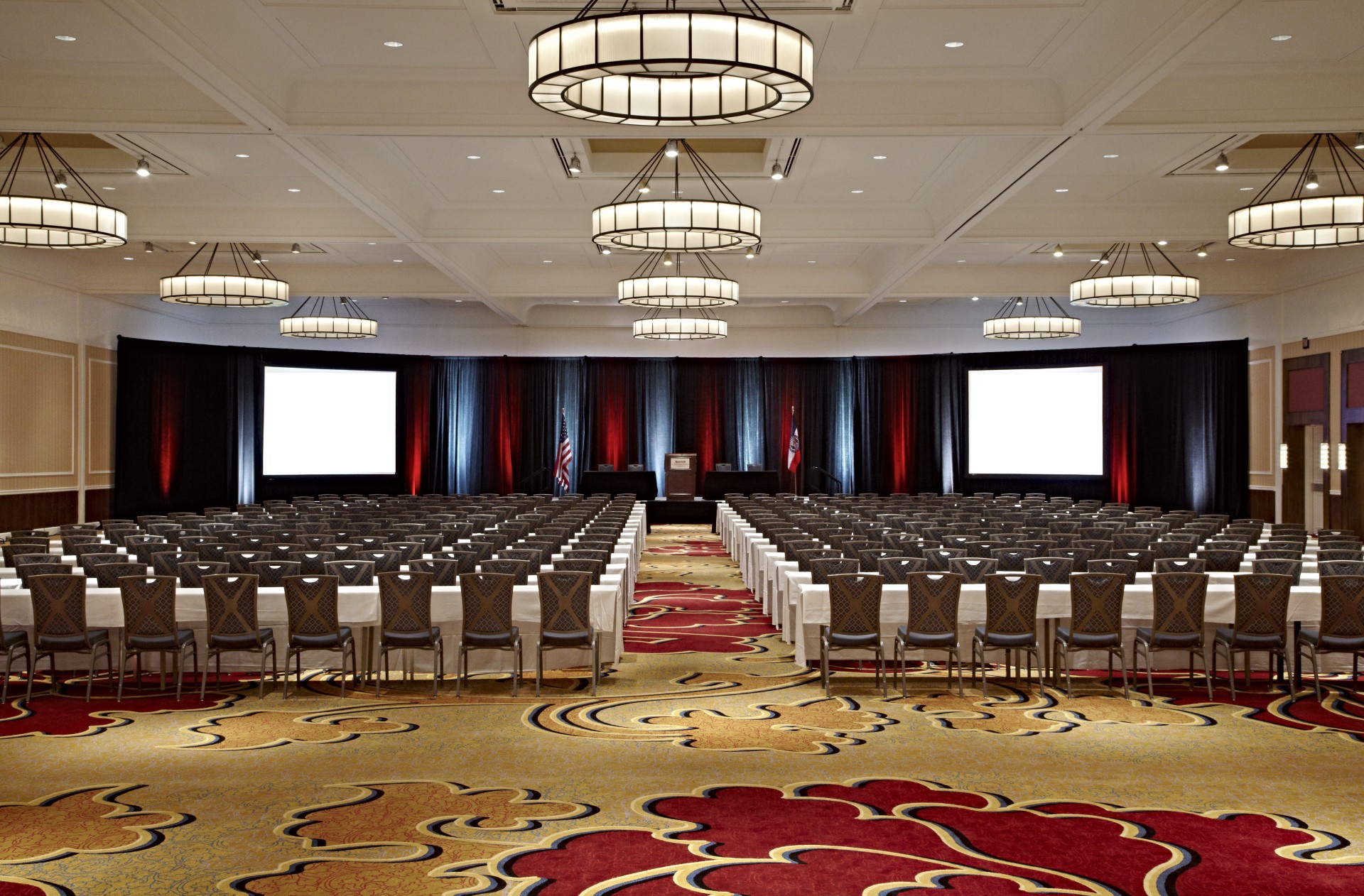 a large room with chairs and a large screen
