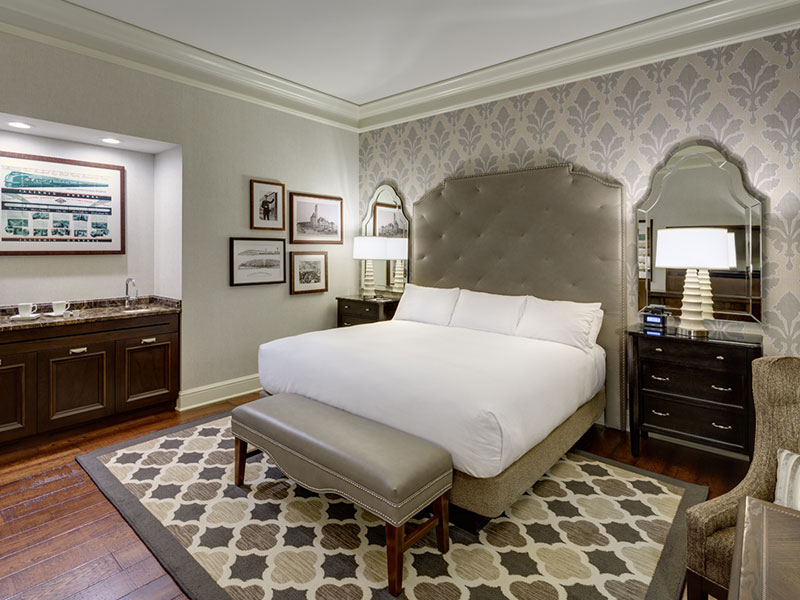 a bedroom with a bed and a rug