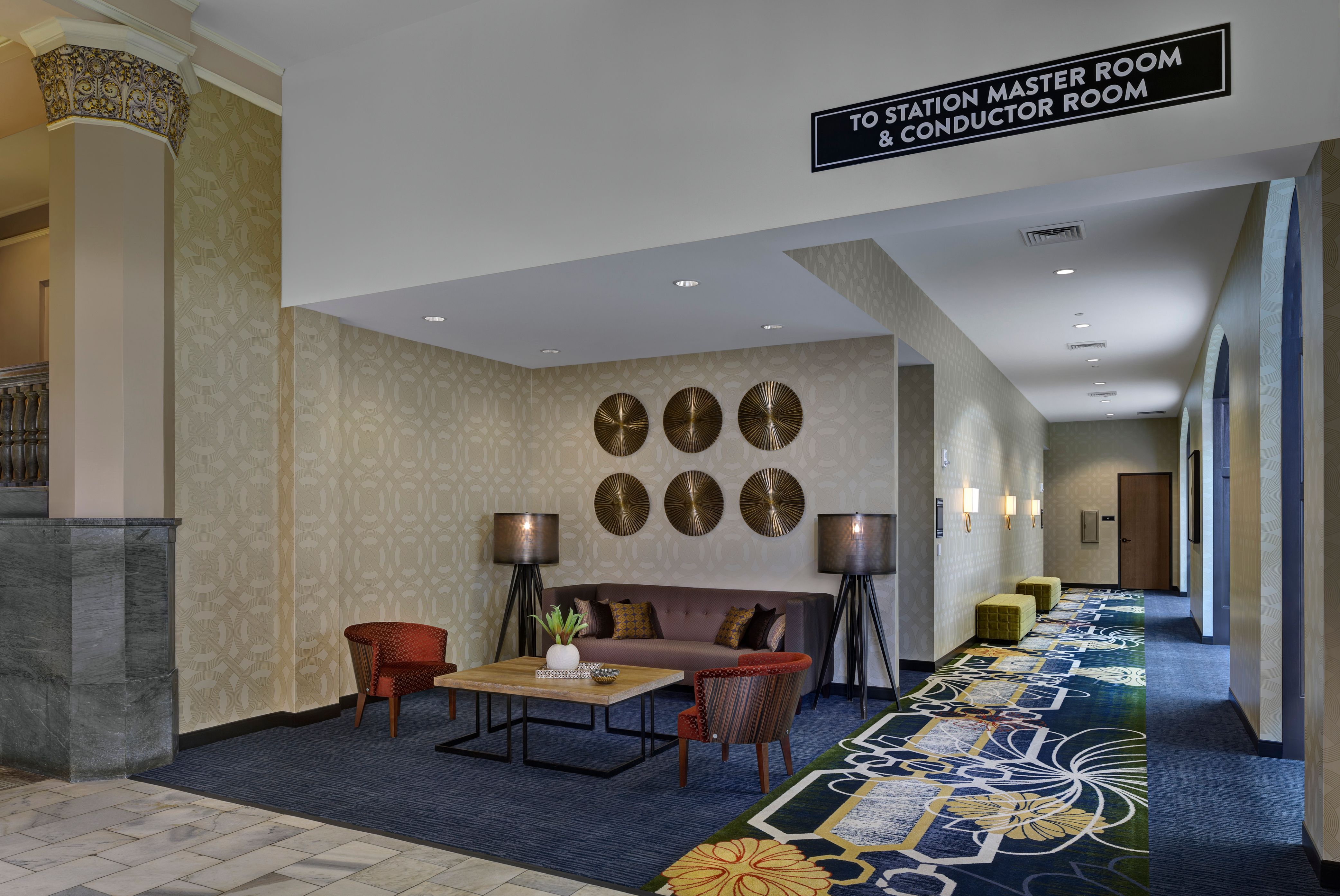 a lobby with a couch and chairs