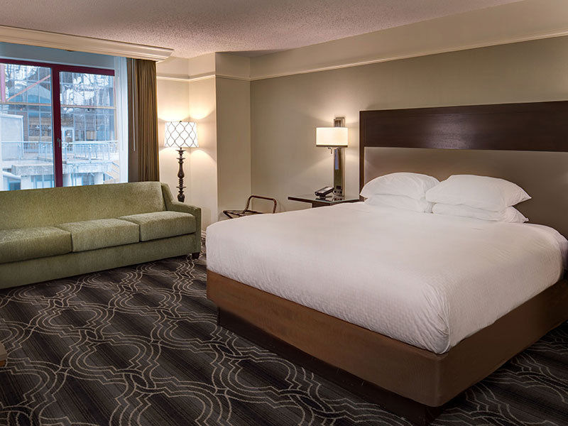 a hotel room with a bed and a couch
