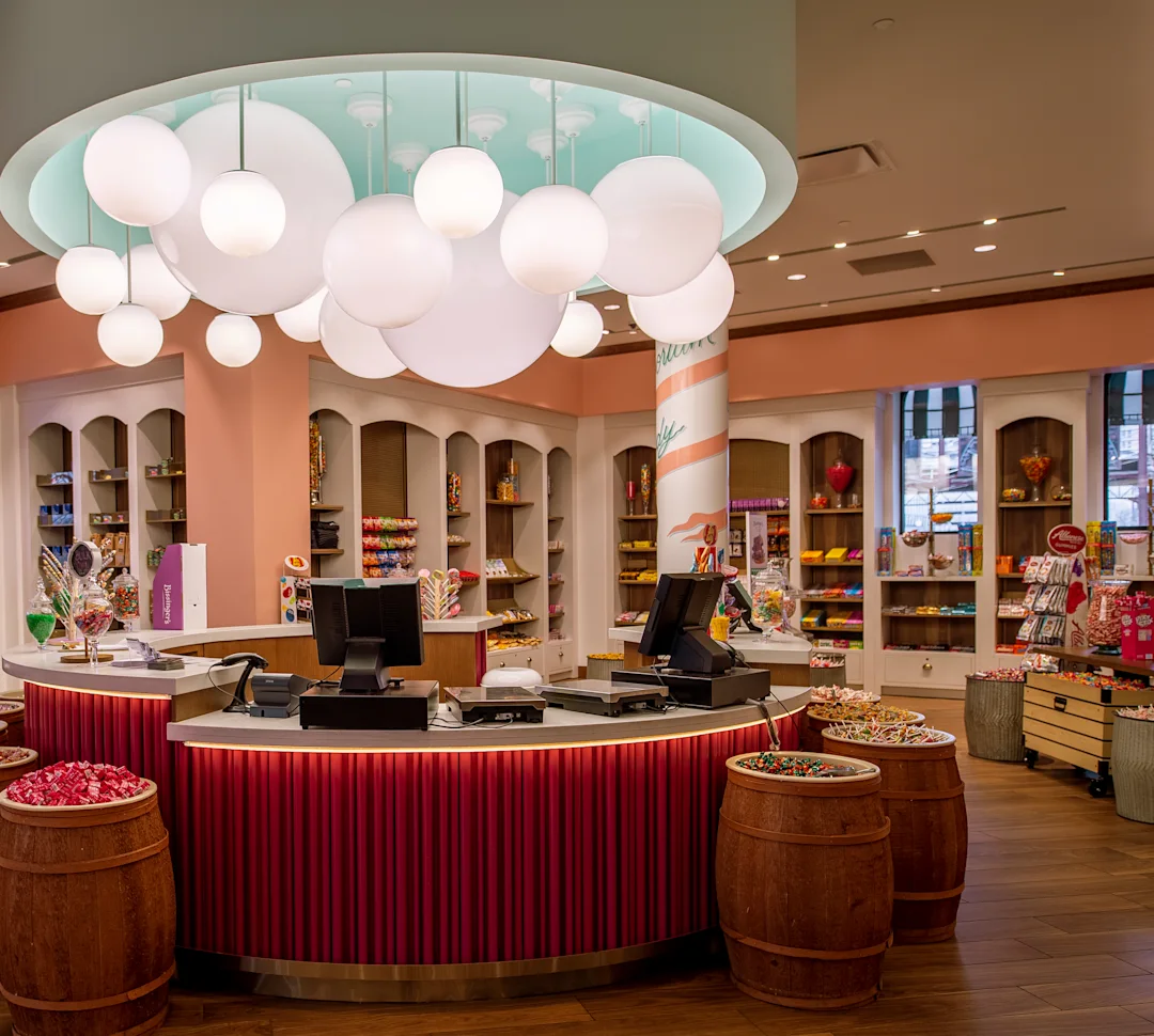 a candy store with a counter and barrels