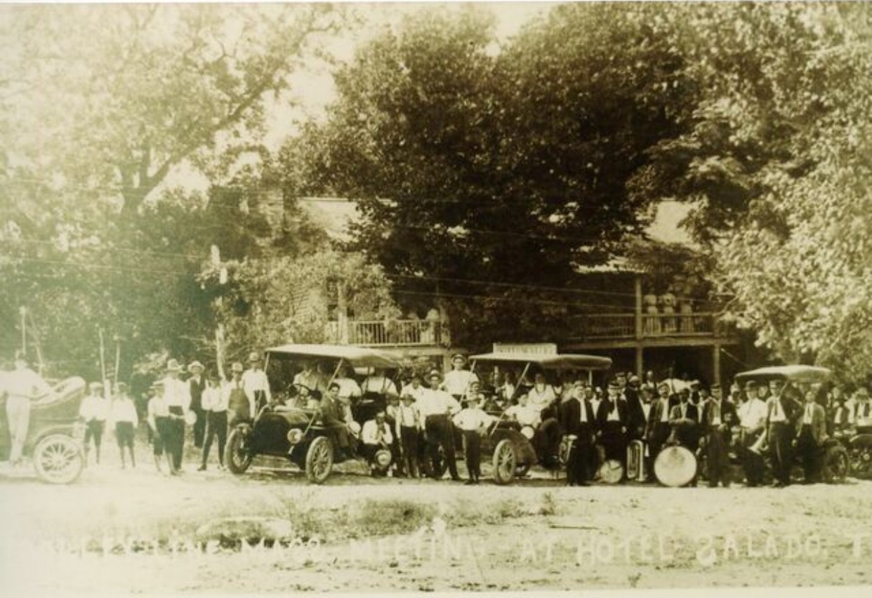 a group of people standing next to a car